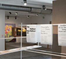 installation view of Question of Funding's installation for documenta fifteen. A gallery space with paitings and text can be seen