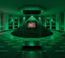 a large sand pyramid in the center of a room is illuminated with a green light, in front of it a small painting my Henri Rousseau is mounted on a clear glass wall